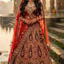 Bride in vintage zari bridal lehenga with gold embroidery, standing by temple steps