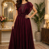 Woman in wine maroon evening gown with embellished bodice, front view